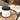 Lantern & Veil Beachcomber Bliss satin signature lotion jar on a stone surface with wooden logs in the background.