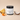 Lantern & Veil Beachcomber Bliss lotion jar with pineapple, coconut, and orange on a beige background