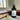 Room spray bottle labeled 'Boston Brownstone' by Lantern & Veil on a marble surface with books and a lemon.