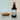Black spray bottle labeled 'Citrus Horizon' by Lantern & Veil on a light surface with orange slices.