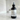 Black bottle of 'Crimson Ember' body fragrance spray on a marble countertop