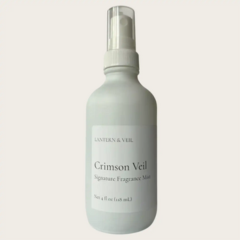White spray bottle with Crimson Veil fragrance mist by Lantern & Veil on a beige background.