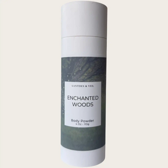 Body powder container labeled 'Enchanted Woods' by Lantern & Veil on a light gray background