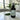 Black spray bottle labeled 'Jungle Navigation Co' on a marble surface with jungle inspired plants in the background