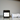 Black container labeled 'Key Lime Soaking Salts' on a marble surface with a white towel.