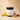 Lantern & Veil Mango Dragonfruit satin signature lotion jar with fruit slices on a beige background