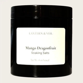 Black container of Mango Dragonfruit soaking salts by Lantern & Veil on a light gray background