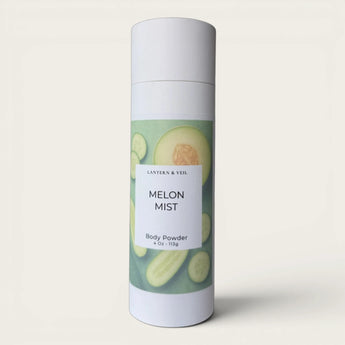 Body powder canister labeled 'Melon Mist' with a gray background