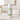 Body powder tube labeled 'Melon Mist' on a bathroom counter with towels and faucet in the background.