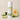 Melon Mist body powder tube with melon and cucumber slices on a beige background