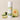 Melon Mist body powder canister with melon and cucumber slices on a beige background