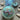 Decorative bath bomb with mermaid-themed elements on a textured surface.