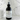 Black spray bottle labeled 'Midnight Lounge' on a marble surface