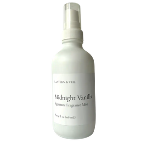 White bottle of 'Midnight Vanilla' fragrance mist on a white background