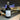 Black spray bottle labeled 'Midnight Vanilla' with a cityscape in the background