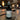 Bottle of 'Ohana' room & linen spray on a wooden table with a blurred background