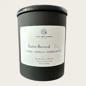 A black glass jar candle with a white label reading 'Retro Revival ' on a light beige background.