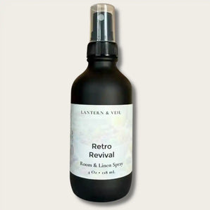 Room and linen spray bottle labeled 'Retro Revival' by Lantern & Veil on a light gray background