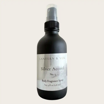 Black body fragrance spray bottle labeled 'Rum Noir' by Lantern & Veil on a light gray background