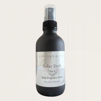 Black body fragrance spray bottle labeled 'Solar Drift' on a light beige background