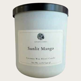 Candle with 'Sunlit Mango' label on a light gray background