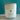 A 12 oz glass jar candle with coconut wax and a light wood lid, featuring a white label that reads 'Tidewater Spa Enchanted Escapes'