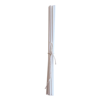 Set of white diffuser reeds tied together on a white background