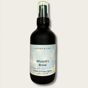 Black spray bottle labeled 'Wizard's Brew' by Lantern & Veil on a light gray background