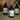 Three Lantern & Veil room sprays bottles placed on a light wood table, amber lighting, cozy home background.