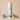 Body powder canister labeled 'Aegean Coast' with decorative elements on a beige background