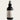 Black room and linen spray bottle labeled 'The Atrium' by Lantern & Veil on a light gray background