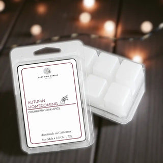 Packaged wax melts with 'Autumn Homecoming' label on a dark background
