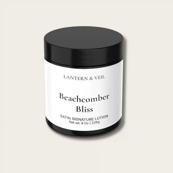Lotion jar labeled 'Beachcomber Bliss' by Lantern & Veil on a light beige background