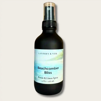 Black spray bottle labeled 'Beachcomber Bliss' by Lantern & Veil on a light gray background