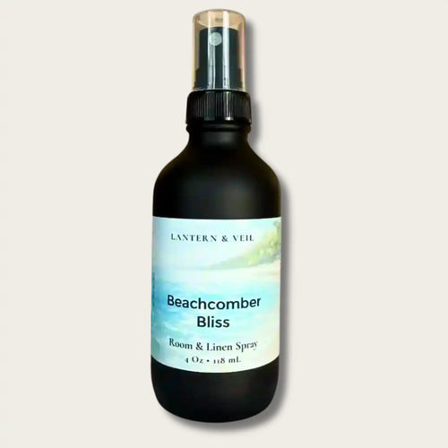 Black spray bottle labeled 'Beachcomber Bliss' by Lantern & Veil on a light gray background