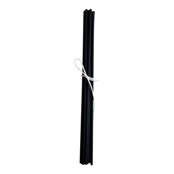 Set of black fiber diffuser reeds tied with white string on a white background