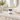 Blackwood Estate Satin Signature Lotion: Handmade body lotion jar on a marble bathroom counter with gold fixtures and a mirror.