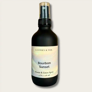 Bottle of 'Bourbon Sunset' room & linen spray by Lantern & Veil on a light gray background