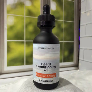 Bottle of Lantern & Veil Beard Conditioning Oil with a dropper on a surface near a window.