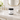 Carioca Nights satin signature handmade body lotion on a bathroom counter with marble and gold fixtures.