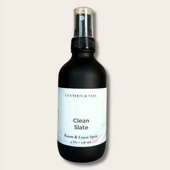 Black spray bottle labeled 'Clean Slate' by Lantern & Veil on a light beige background
