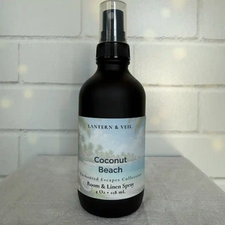 Room and linen spray bottle labeled 'Coconut Beach' by Lantern & Veil on a light surface with a tiled wall background.
