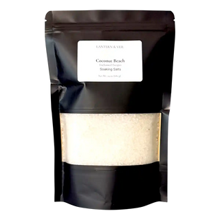 Black packaging of coconut beach soaking salts with a visible label on a white background