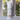 Body powder canister labeled 'Desert Drifter' on a windowsill with a blurred outdoor background