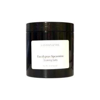 Black container of Eucalyptus Spearmint Soaking Salts with a white label on a white background