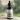 Bottle of Lantern & Veil Beard Conditioning Oil with a mountain label against a blurred green background.