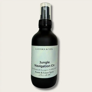 Black room and linen spray bottle labeled 'Jungle Navigation Co' on a light gray background