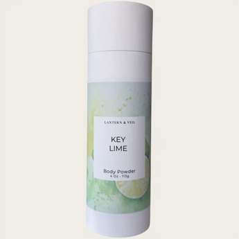Body powder canister labeled 'Key Lime' by Lantern & Veil on a light gray background