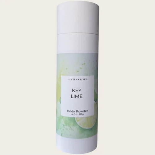 Body powder canister labeled 'Key Lime' by Lantern & Veil on a light gray background