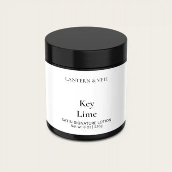 Lantern & Veil Key Lime satin signature lotion jar on a light beige background
